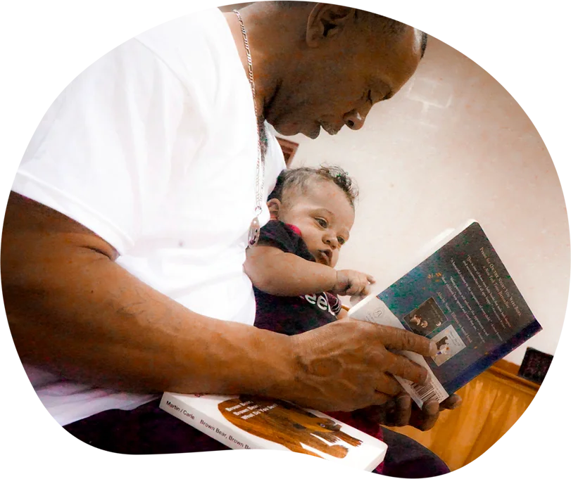 Man reading to toddler.